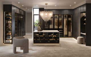 Large walk in wardrobe with an island bench and plenty of storage space